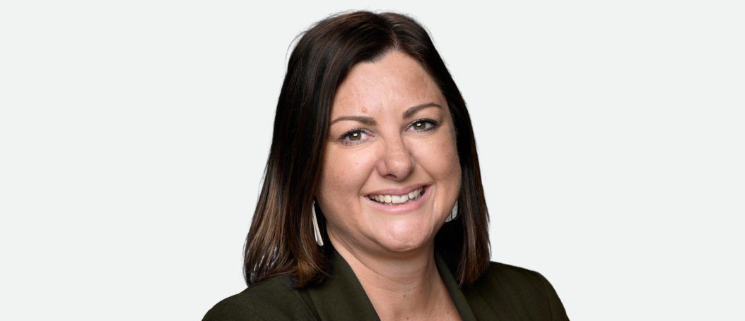 Kristy McBain MP smiles to the camera, she is wearing a suit jacket. 