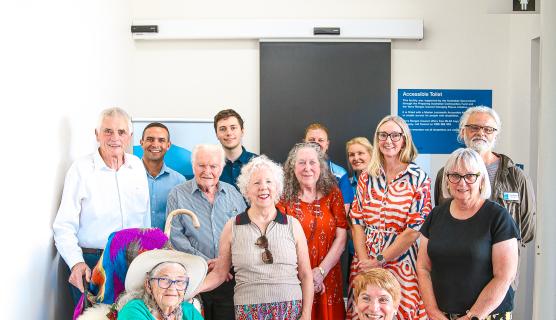 A photo of members of the Yarra Ranges Disability Advisory Committee gathered together outside an accessible toilet.
