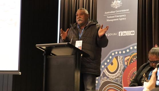 A man behind a lectern addresses the audience at Exercise Convergence 2025