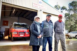 An image of three people outside a fire station on Bruny Island