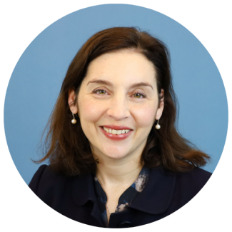 Headshot of Jill with light blue background, with light blue background, cropped to a circle.