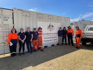 NEMS staff in front of pallet 