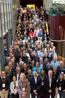 Large group photo of summit attendees packed on a staircase.